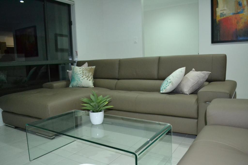 Lounge with a large L-shaped sofa and glass coffee table