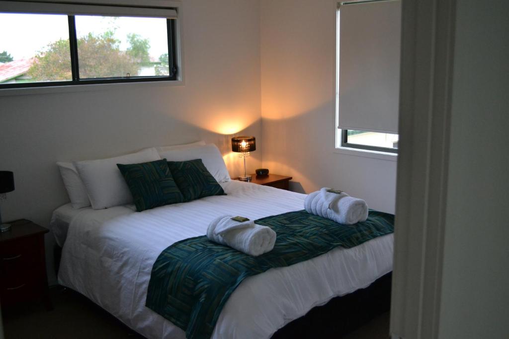 Second bedroom with a large double bed, teal throw and fresh towels