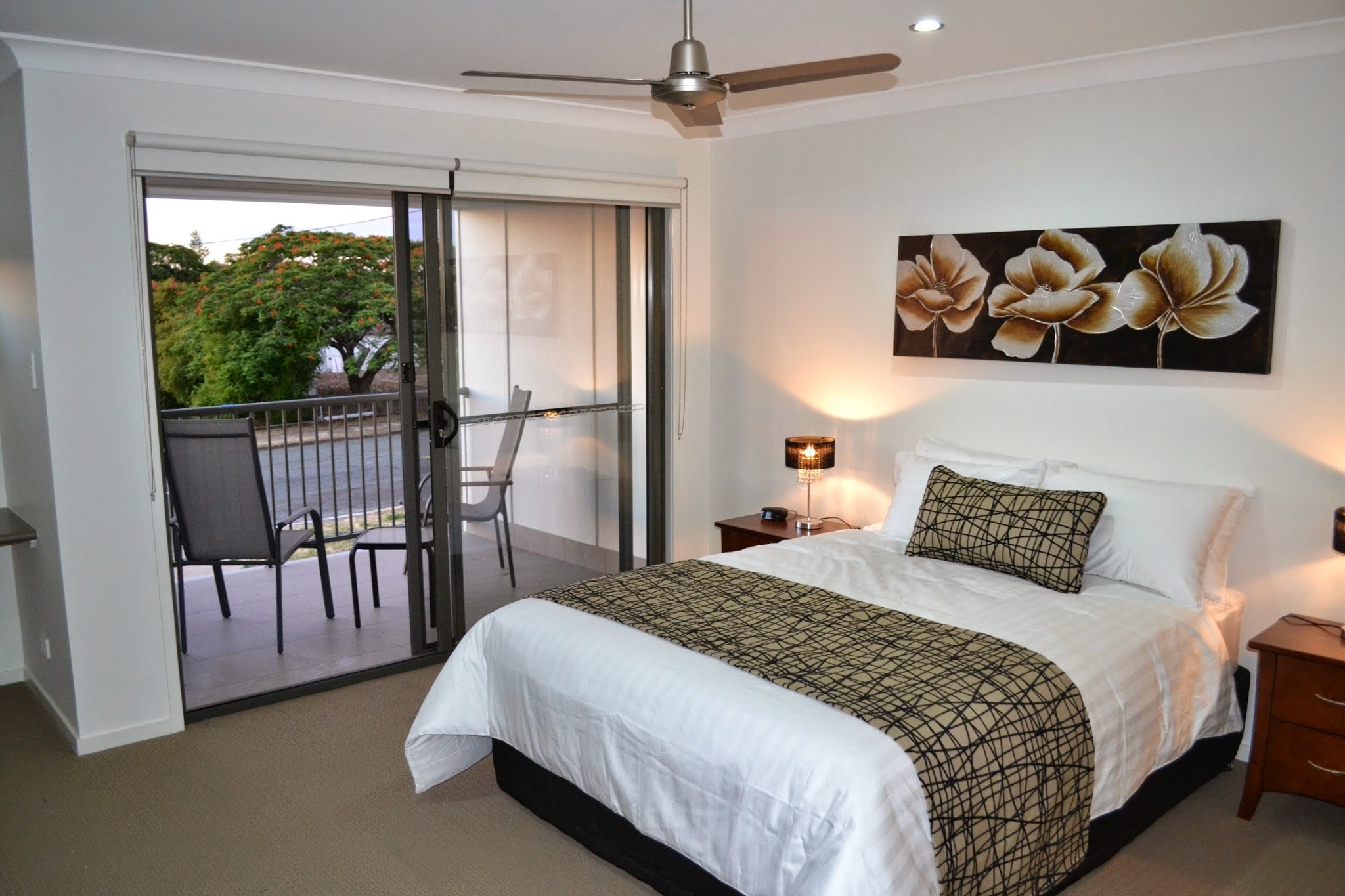 Main bedroom with a large double bed and a sliding door to the balcony